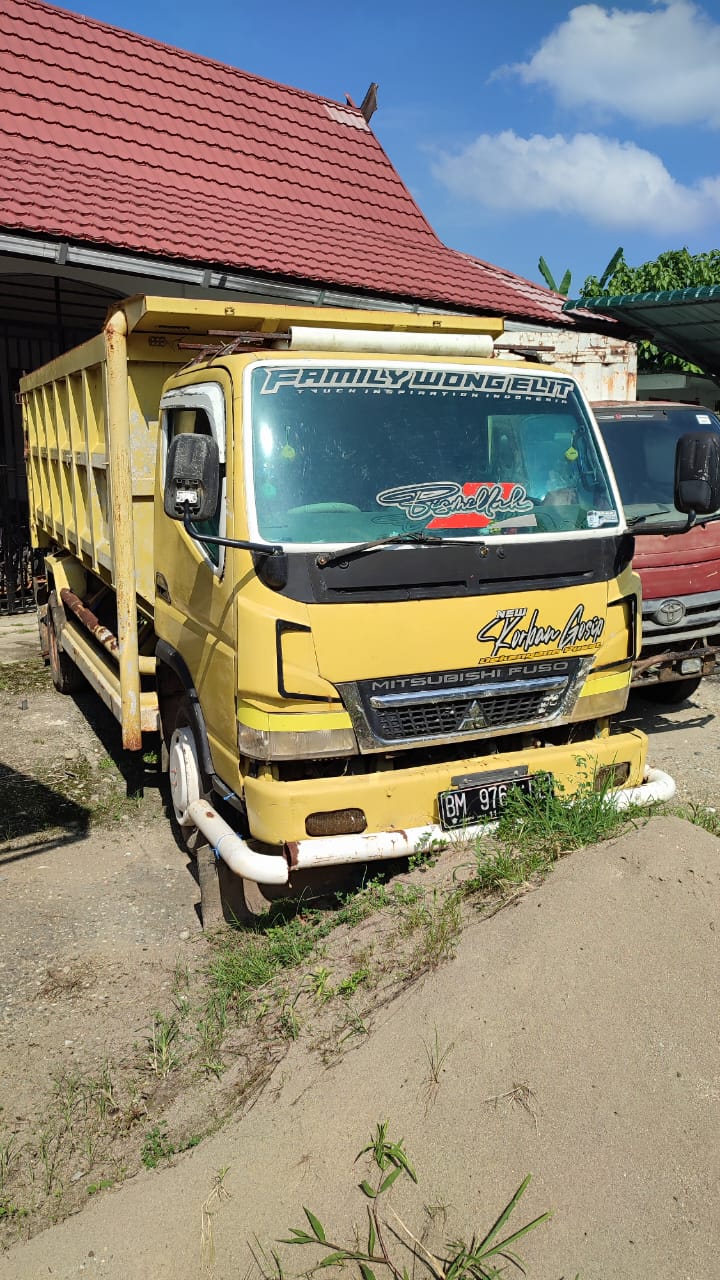 1 (satu) unit angkutan (darat) mobil mitsubishi canter warna kuning nomor polisi BM 9764 DE.